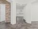 Elegant hallway with stone accent wall and tile flooring at 2364 Boretto St, Henderson, NV 89044