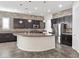 Modern kitchen with dark cabinetry, granite countertops, and large island at 2364 Boretto St, Henderson, NV 89044