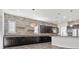 Modern kitchen with dark cabinetry and stone feature wall at 2364 Boretto St, Henderson, NV 89044