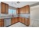 Modern kitchen with wood cabinets, granite countertops, and stainless steel appliances at 2526 Rocky Countryside St, North Las Vegas, NV 89030