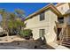 Rear exterior view of condo building showcasing stairs and landscaping at 2633 S Durango Dr # 201, Las Vegas, NV 89117