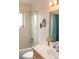 Bright bathroom featuring a shower-tub combination and white-tiled walls at 3008 Blue Fin Cir, Las Vegas, NV 89128