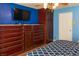 Bedroom with blue walls, hardwood floors, and a large dresser at 3008 Blue Fin Cir, Las Vegas, NV 89128