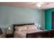 Primary bedroom with a large bed and teal walls at 3008 Blue Fin Cir, Las Vegas, NV 89128