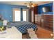 Main bedroom with blue walls, hardwood floors, and ample closet space at 3008 Blue Fin Cir, Las Vegas, NV 89128