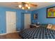 Bedroom with light blue walls, wood floors, and a ceiling fan at 3008 Blue Fin Cir, Las Vegas, NV 89128