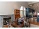 Elegant dining area with a table set for six, a fireplace, and natural light from arched windows at 3008 Blue Fin Cir, Las Vegas, NV 89128