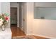 The hallway leads to a bedroom; light gray walls and faux-wood floors give this home a cohesive feel at 3008 Blue Fin Cir, Las Vegas, NV 89128