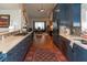 Spacious kitchen with blue cabinets, stainless steel appliances, and mosaic backsplash at 3008 Blue Fin Cir, Las Vegas, NV 89128