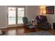 Living room with hardwood floors, rocking chairs, and view of the pool at 3008 Blue Fin Cir, Las Vegas, NV 89128