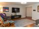 Comfortable living room featuring a television, modern furniture, and wood flooring at 3008 Blue Fin Cir, Las Vegas, NV 89128