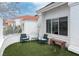 Inviting outdoor patio with comfortable seating, artificial grass, and a serene atmosphere at 3008 Blue Fin Cir, Las Vegas, NV 89128