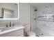 Bathroom featuring a marble tile shower, modern vanity with gold fixtures, and a large mirror at 3012 Holly Hill Ave, Las Vegas, NV 89104