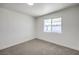 Bright bedroom with a large window and neutral carpet and baseboards at 3012 Holly Hill Ave, Las Vegas, NV 89104