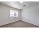 Bedroom featuring neutral carpet, natural light, and minimalist design elements at 3012 Holly Hill Ave, Las Vegas, NV 89104