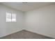 Bright bedroom featuring neutral carpet, baseboards and window at 3012 Holly Hill Ave, Las Vegas, NV 89104