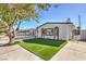 Charming curb appeal featuring a single story home with artificial turf at 3012 Holly Hill Ave, Las Vegas, NV 89104