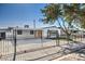 Single story home with a beautifully landscaped front yard and black fence at 3012 Holly Hill Ave, Las Vegas, NV 89104