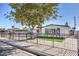 Charming single-story home featuring a black iron fence, modern windows, and a meticulously maintained front yard at 3012 Holly Hill Ave, Las Vegas, NV 89104