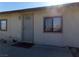 Light beige single story home with a small front yard at 3381 W Simkins Rd, Pahrump, NV 89060