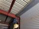 Garage ceiling featuring metal support beams, lighting, and rolling door assembly at 3381 W Simkins Rd, Pahrump, NV 89060