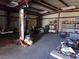 Open garage featuring vehicle lifts, shelving, and plenty of storage space at 3381 W Simkins Rd, Pahrump, NV 89060