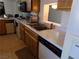 Kitchen with wood cabinets, white appliances and dishwasher at 3381 W Simkins Rd, Pahrump, NV 89060