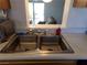 Double kitchen sink with pass-through window at 3381 W Simkins Rd, Pahrump, NV 89060