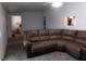 Relaxing living room, featuring a brown sectional sofa and carpet flooring at 3381 W Simkins Rd, Pahrump, NV 89060