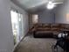 Spacious living room with a large sectional sofa and patio access at 3381 W Simkins Rd, Pahrump, NV 89060