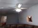 Bright living room with a ceiling fan and pass-through kitchen view at 3381 W Simkins Rd, Pahrump, NV 89060