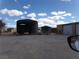 View of multiple sheds, with open bays, under a partly cloudy sky at 3381 W Simkins Rd, Pahrump, NV 89060