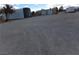 A wide gravel lot featuring metal sheds, various outbuildings and a vast, open space at 3381 W Simkins Rd, Pahrump, NV 89060