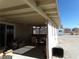 Covered patio with ceiling fan, table, chairs, and lattice walls at 3381 W Simkins Rd, Pahrump, NV 89060