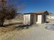 Small shed in a rural location with a door and weathered exterior at 3381 W Simkins Rd, Pahrump, NV 89060