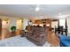 Living room with open layout, brown leather seating and ceiling fan at 3811 E Chaffe Ave, Pahrump, NV 89061