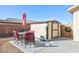 Tan and beige storage shed in backyard with patio furniture at 3811 E Chaffe Ave, Pahrump, NV 89061