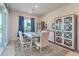 Dining room with gray table, white chairs, and built-in cabinets at 4390 E Cactus Canyon Dr, Pahrump, NV 89061