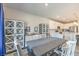 Bright dining room with grey table and white chairs, adjacent to kitchen at 4390 E Cactus Canyon Dr, Pahrump, NV 89061