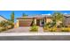 One-story home with brown garage door and landscaped front yard at 4390 E Cactus Canyon Dr, Pahrump, NV 89061