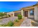 Front view of house with brown door and brick walkway at 4390 E Cactus Canyon Dr, Pahrump, NV 89061