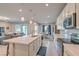 Spacious kitchen with island, stainless steel appliances, and view into living room at 4390 E Cactus Canyon Dr, Pahrump, NV 89061