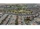 Wide aerial view of a large neighborhood with a golf course nearby at 4435 Lavender Ln, Pahrump, NV 89061