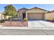 Single-story house with a two-car garage and desert landscaping at 4435 Lavender Ln, Pahrump, NV 89061