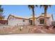 One-story house with gravel yard and palm trees at 4527 Buddy Holly Ct, North Las Vegas, NV 89031