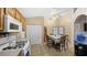 Kitchen with wood cabinets, gas stove and dining area at 4527 Buddy Holly Ct, North Las Vegas, NV 89031