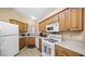 Kitchen with wood cabinets and gas stove at 4527 Buddy Holly Ct, North Las Vegas, NV 89031