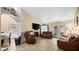 Living room with leather sofas, fireplace, and view of dining area at 4527 Buddy Holly Ct, North Las Vegas, NV 89031