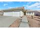 Single-story house featuring a two-car garage and well-maintained landscaping at 4722 Casa Bonita Dr, North Las Vegas, NV 89032