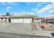 Single-story home with two-car garage and landscaped front yard at 4722 Casa Bonita Dr, North Las Vegas, NV 89032